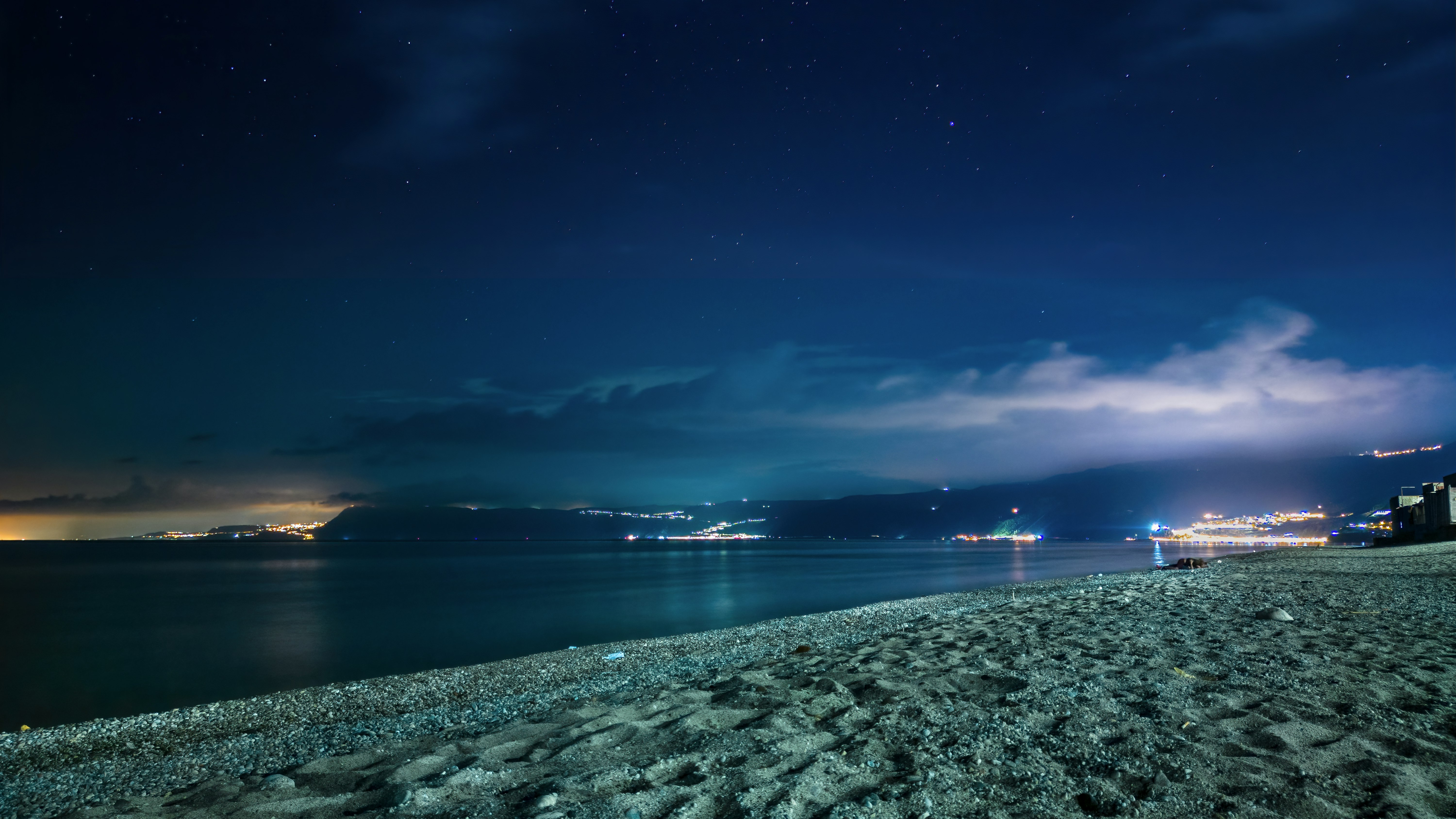 body of water under blue sky during night time